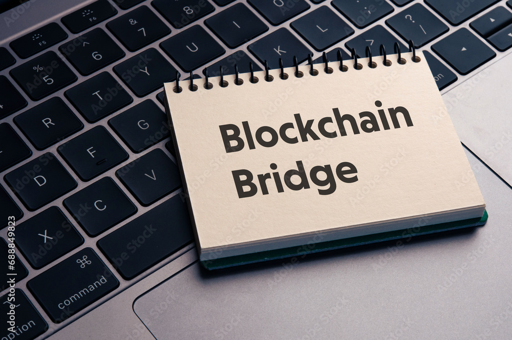 Poster there is notebook with the word blockchain bridge. it is as an eye-catching image.