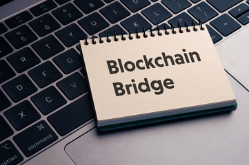 There is notebook with the word Blockchain Bridge. It is as an eye-catching image.