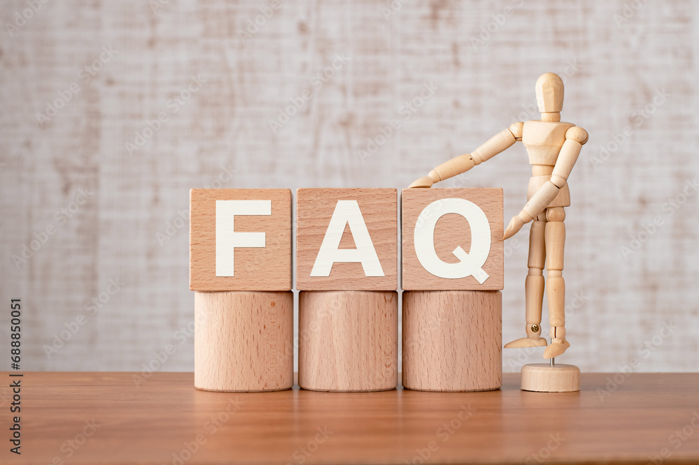 Poster there is wood cube with the word faq. it is an abbreviation for frequently asked questions as eye-ca
