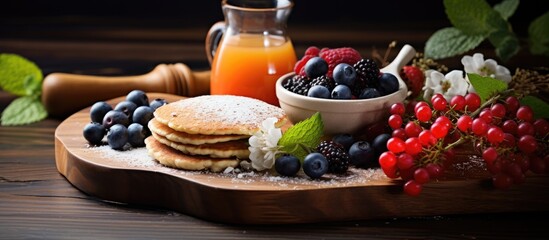Delicious and healthy breakfast with cottage cheese pancakes and fresh fruits on a wooden board.