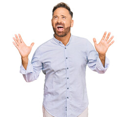 Fototapeta premium Handsome middle age man wearing business shirt crazy and mad shouting and yelling with aggressive expression and arms raised. frustration concept.