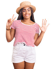 Obraz na płótnie Canvas Young african american woman with braids wearing summer hat showing and pointing up with fingers number seven while smiling confident and happy.
