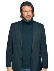 Fototapeta premium Middle age handsome man wearing business clothes depressed and worry for distress, crying angry and afraid. sad expression.