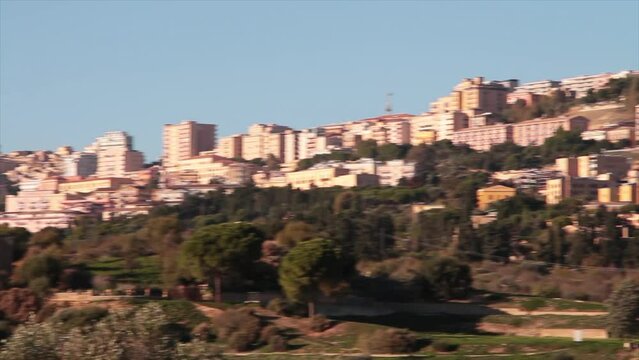 agrigento sicily italy buildings homes houses on hill pan left to right medium shot