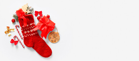 Beautiful Christmas sock with gifts and decorations on white background with space for text