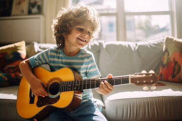 Cute little boy learning to play guitar in living room. Child having fun with music instrument. Art education for kids. - obrazy, fototapety, plakaty