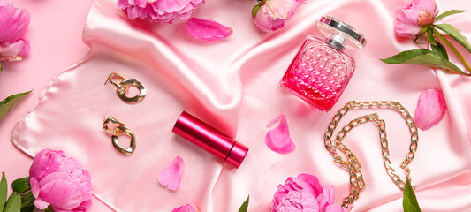 Composition with stylish female accessories, cosmetics and beautiful peony flowers on pink background
