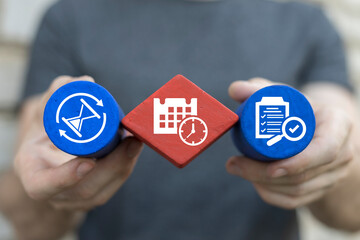 Man holding multi-colored blocks sees icon symbolizing time: calendare with clock. Time management...