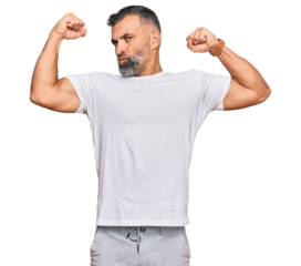 Middle age handsome man wearing casual white tshirt showing arms muscles smiling proud. fitness concept.