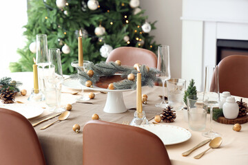 Festive table setting with fir tree branches and Christmas balls
