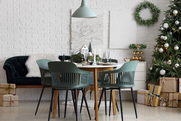 Festive table setting with Christmas decor in light room