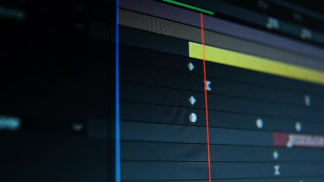 Dolly tracking shot of a computer screen in video editing software. Moving keyframes of film. Low depth of field. 