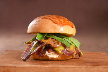 beef burger sandwich brioche bun with melted cheese, lettuce, tomato, mayonnaise and bread delicious fast food traditional snack