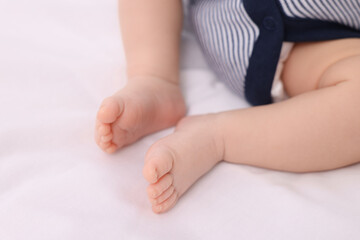 Fototapeta na wymiar Newborn baby lying on white blanket, closeup
