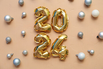 Figure 2024 made of balloons with Christmas balls on beige background
