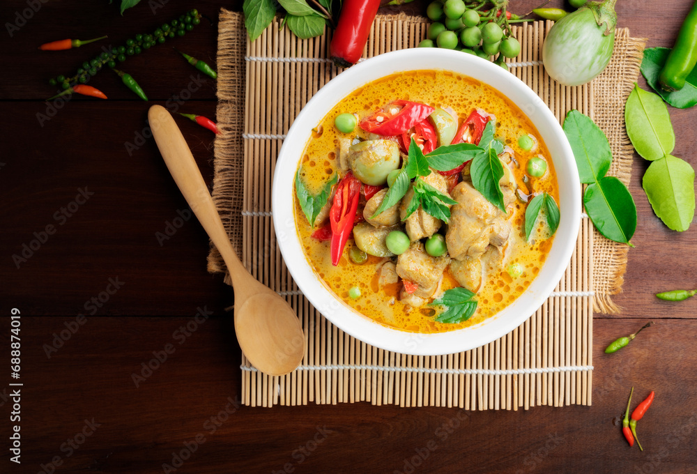 Wall mural chicken green curry asian food, beef green curry thai food on a soup bowl with a mixture of herbs, v