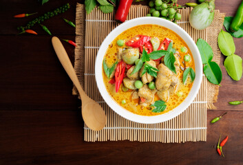 Chicken green curry Asian food, Beef green curry Thai food on a soup bowl with a mixture of herbs, vegetables and Thai red chilli spices. Top view.