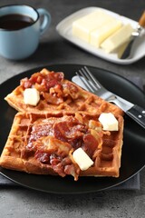 Tasty Belgian waffles served with bacon, butter and coffee on grey table, closeup