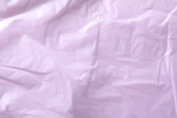 Texture of violet plastic bag as background, closeup