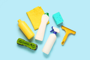 Set of cleaning supplies on blue background