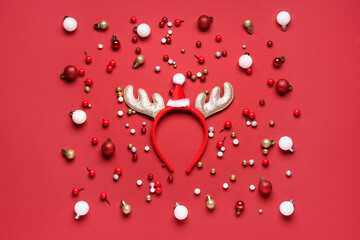 Cute reindeer horns with Christmas decorations on red background