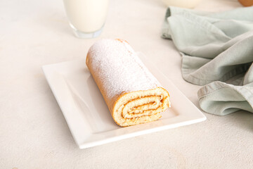 Fototapeta na wymiar Plate with sweet sponge cake roll on white background