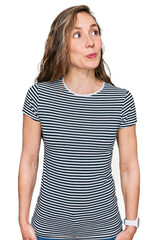 Fototapeta premium Young blonde woman wearing casual clothes smiling looking to the side and staring away thinking.