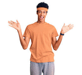 Young african american man wearing sportswear celebrating victory with happy smile and winner expression with raised hands