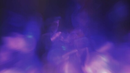 Defocused fluorescent blue purple color bokeh on dark black abstract background