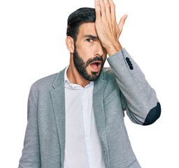 Young hispanic man wearing business clothes surprised with hand on head for mistake, remember...