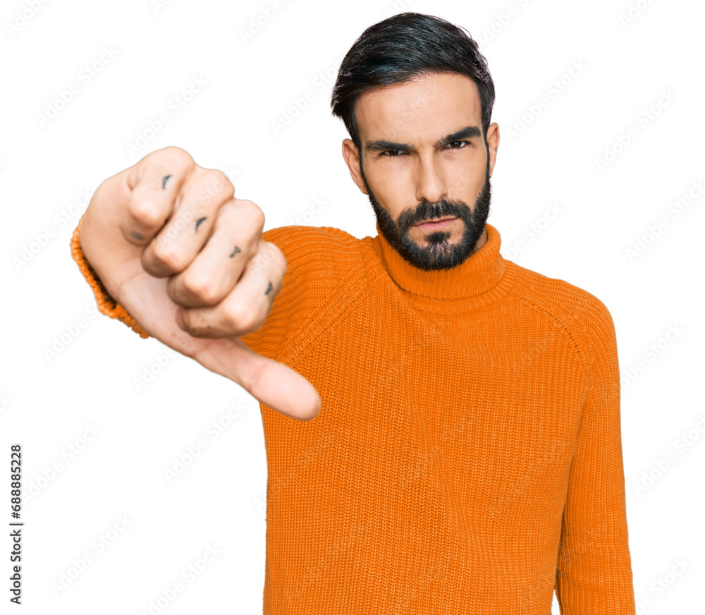 Poster Young hispanic man wearing casual clothes looking unhappy and angry showing rejection and negative with thumbs down gesture. bad expression.