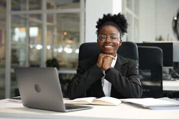 Happy woman working at table in office. Lawyer, businesswoman, accountant or manager