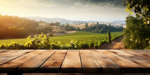 Fotobehang Wooden table overlooking a lush vineyard at sunset, suitable for winery and travel marketing. © StockWorld