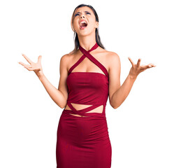 Young beautiful woman wearing casual clothes crazy and mad shouting and yelling with aggressive...