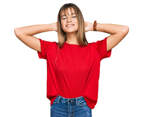 Teenager caucasian girl wearing casual red t shirt relaxing and stretching, arms and hands behind head and neck smiling happy