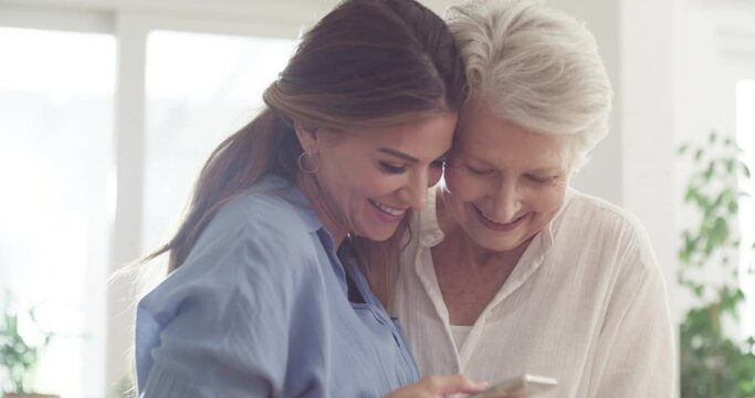 Online, phone and happy with senior mother and woman in family home for relax, laugh and love together. Smile, care and kindness with people and mobile for networking, retirement and generations