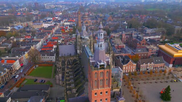 Orbit drone to right over city centre of Den Bosch and St. John's cathedral