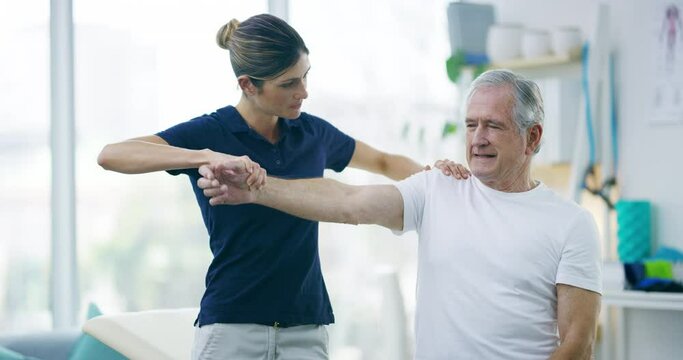 Physiotherapist, senior man and stretching arm, healing arthritis or assessment of muscle rehabilitation, joint pain or injury. Physiotherapy, medical support and chiropractor helping elderly patient
