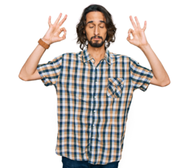 Young hispanic man wearing casual clothes relax and smiling with eyes closed doing meditation gesture with fingers. yoga concept.