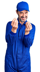 Middle age handsome man wearing mechanic uniform doing money gesture with hands, asking for salary payment, millionaire business