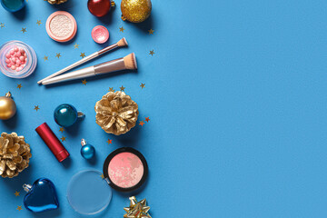 Christmas composition with cosmetics on blue background