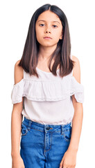 Beautiful child girl wearing casual clothes relaxed with serious expression on face. simple and natural looking at the camera.