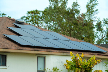 Aerial view building roof with rows of blue solar photovoltaic panels for producing clean...