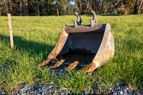 Closeup of excavator bucket scoop attachment at construction work site
