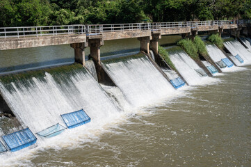 Spillway over a small dam in rural Thailand. Spillway, passage for surplus water over or around a dam when the reservoir itself is full.