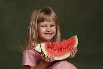 Little girl eats watermelon for the first time.