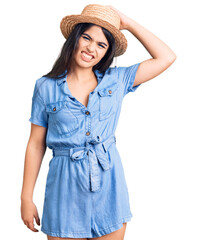 Brunette teenager girl wearing summer hat confuse and wonder about question. uncertain with doubt, thinking with hand on head. pensive concept.