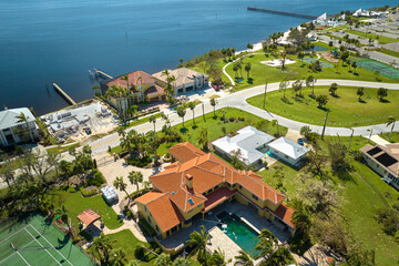 Damaged home rooftops after hurricane Ian in Florida coastal residential area. Consequences of...