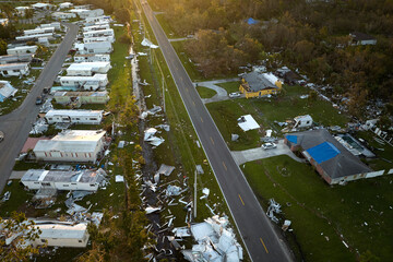 Severely damaged by hurricane Ian houses in Florida mobile home residential area. Consequences of...
