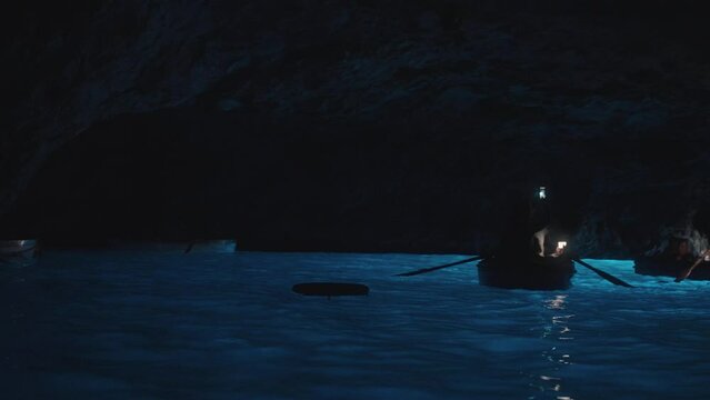 Tourist inside the Blue Cave (Grotta Azzurra) in the island of Capri